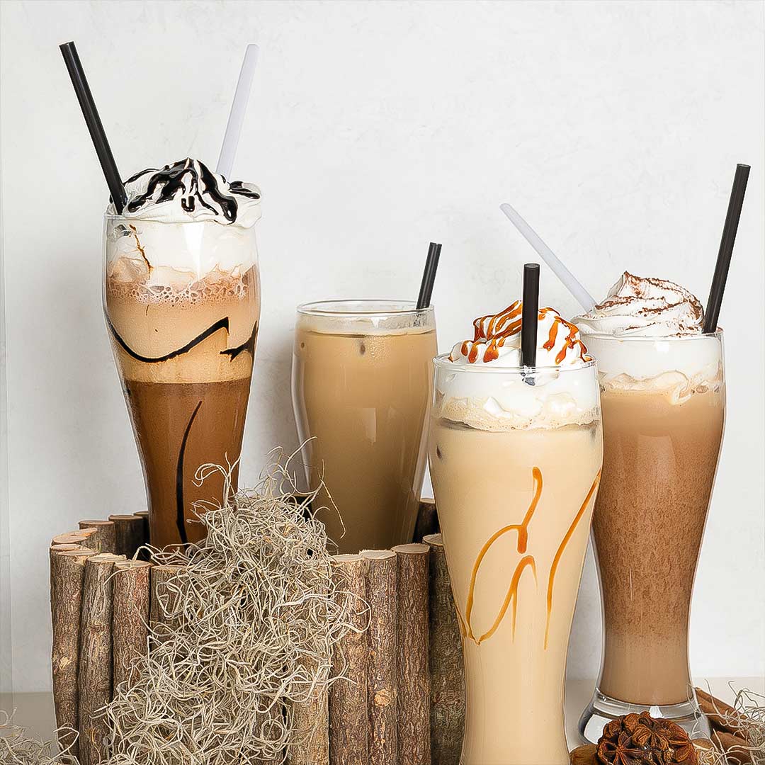 Iced coffee cocktail or frappe with ice cubes and cream in