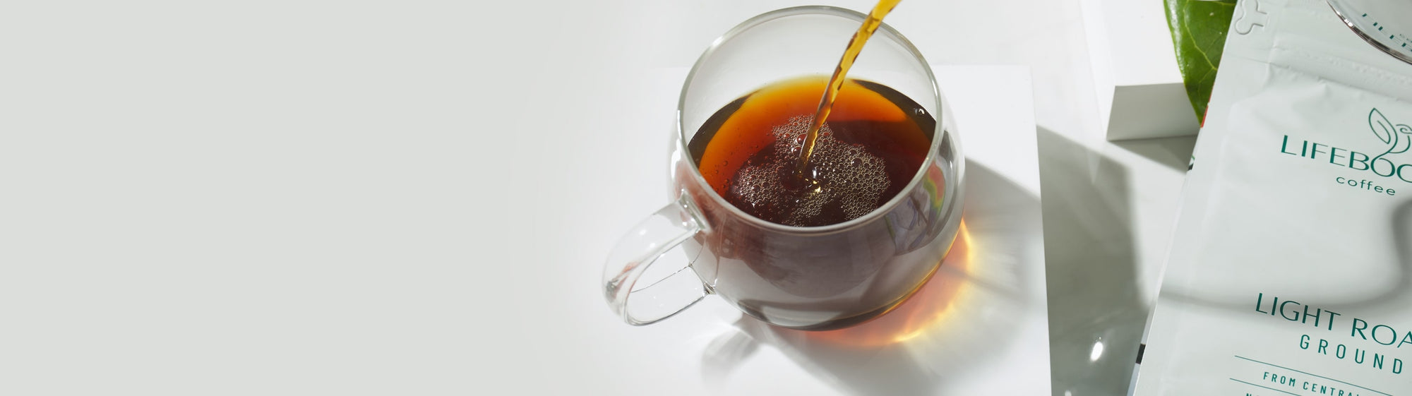 Pouring coffee in a coffee cup